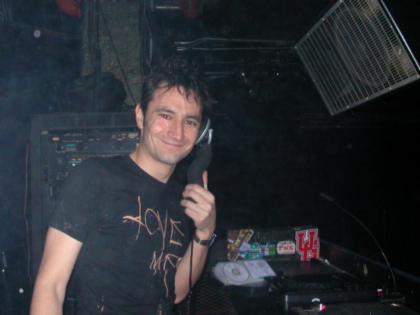 A DJ smiling behind the decks